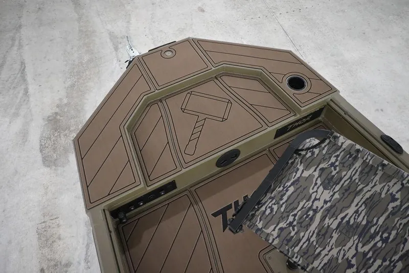 Slide: The Image of 2026 Thor 1754 Timber Hammer boat interior with hammer design and camouflage seat. - 6