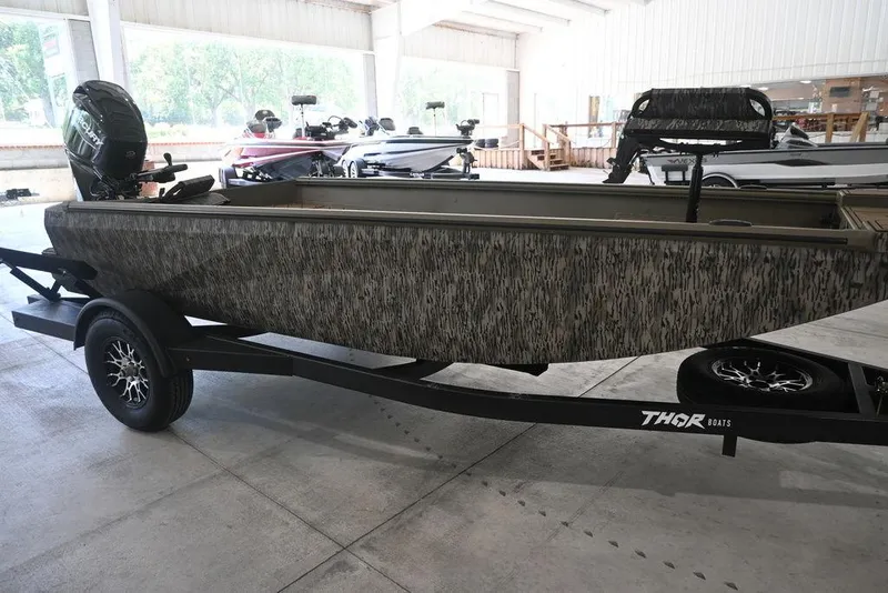Slide: The Image of 2026 Thor 1754 Timber Hammer boat on trailer in showroom. - 7