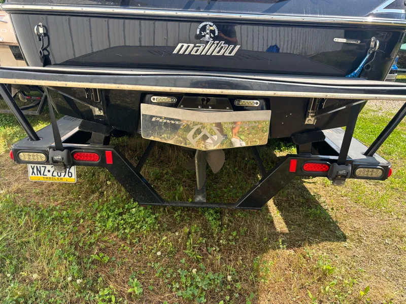 Slide: The Image of Rear view of a 2011 Malibu 21 vRide boat on a trailer. - 11