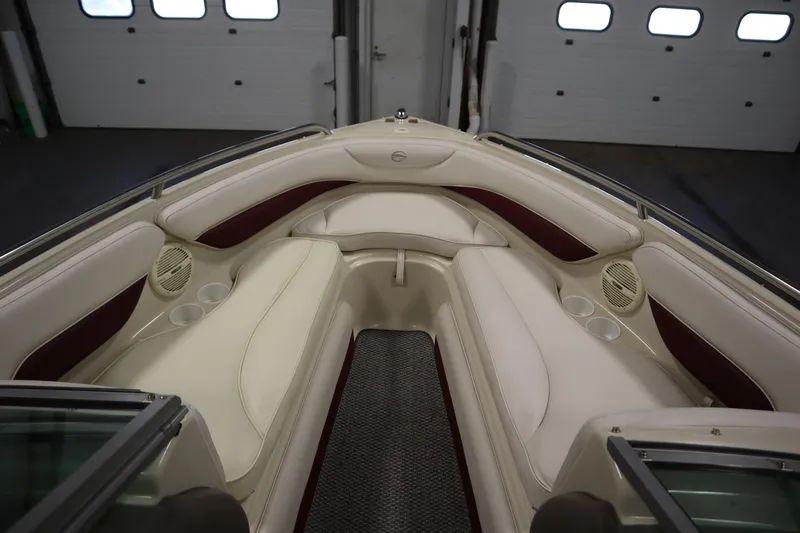 Slide: The Image of Interior of 2003 Crownline 202 BR boat with cream and maroon seating. - 11