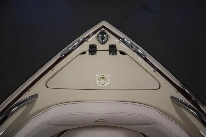 Slide: The Image of Bow of 2003 Crownline 202 BR boat with storage compartment and sleek design. - 12