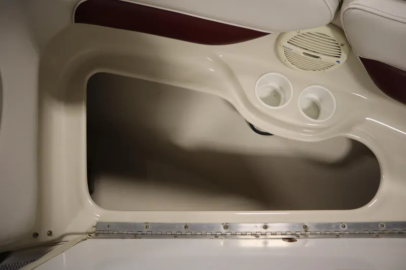 Slide: The Image of Interior of 2003 Crownline 202 BR boat showing storage compartment and cup holders. - 17