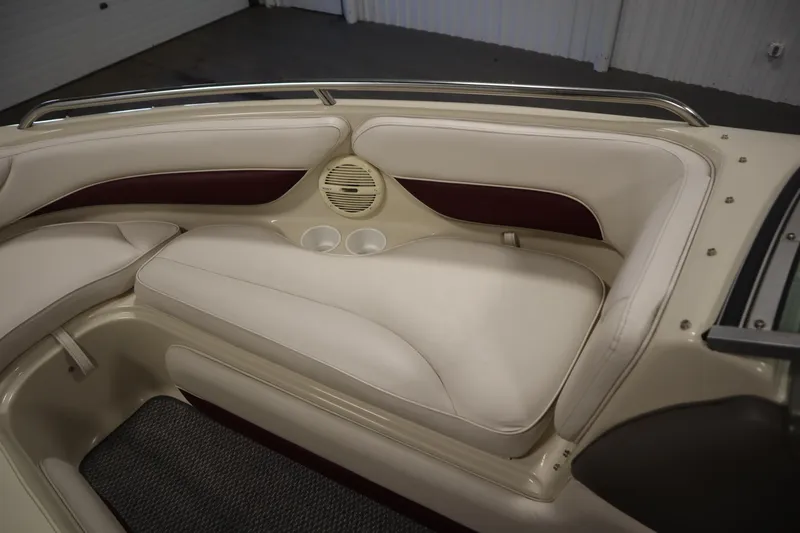 Slide: The Image of 2003 Crownline 202 BR boat interior with beige seating and cup holders. - 18