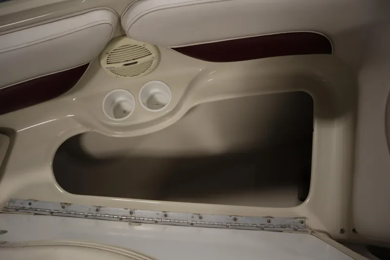Slide: The Image of 2003 Crownline 202 BR boat interior with speaker and cup holders. - 19
