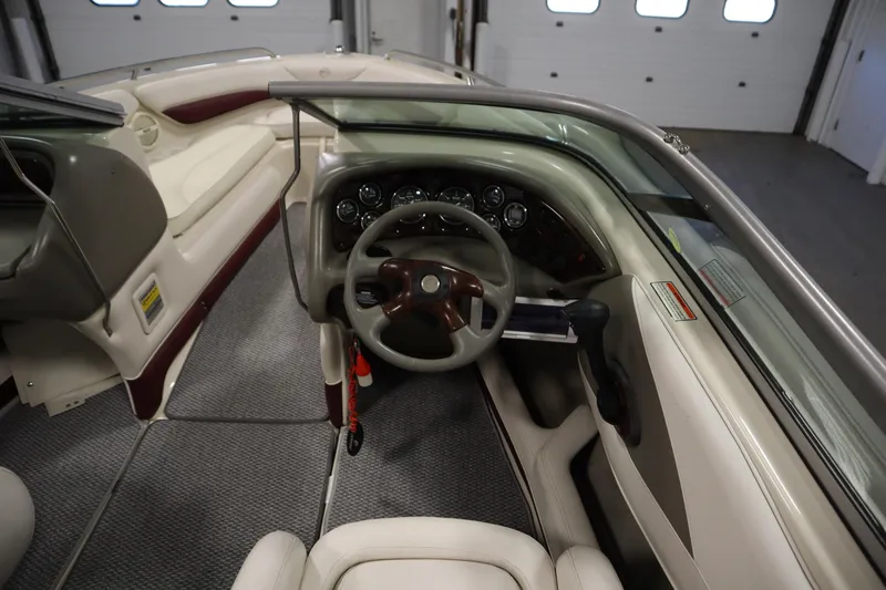 Slide: The Image of 2003 Crownline 202 BR boat interior with steering wheel and dashboard controls. - 21