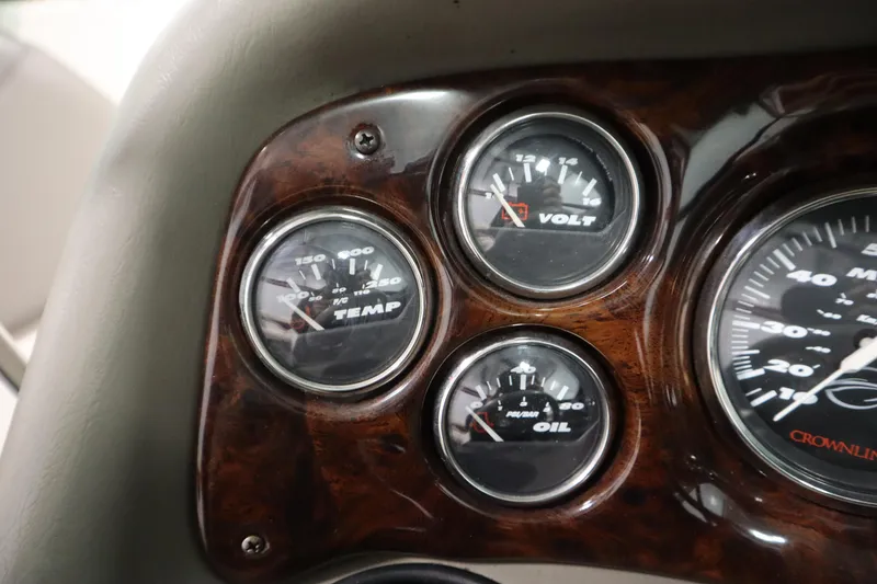 Slide: The Image of Dashboard gauges of a 2003 Crownline 202 BR boat, showing temperature, voltage, and oil levels. - 23