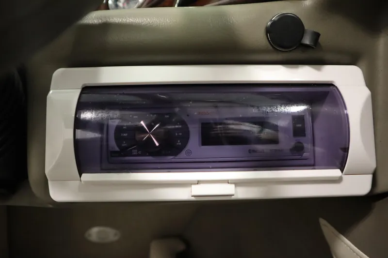 Slide: The Image of Dashboard of a 2003 Crownline 202 BR boat with a covered stereo system. - 27
