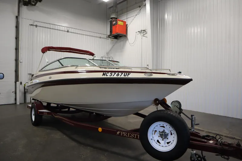 Slide: The Image of 2003 Crownline 202 BR boat on trailer in indoor storage facility. - 3