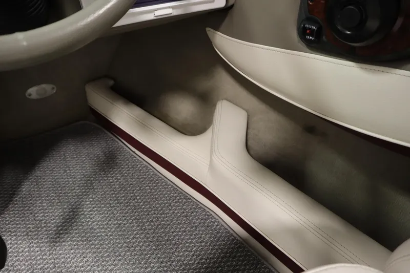Slide: The Image of 2003 Crownline 202 BR interior detail with beige upholstery and carpeted flooring. - 30