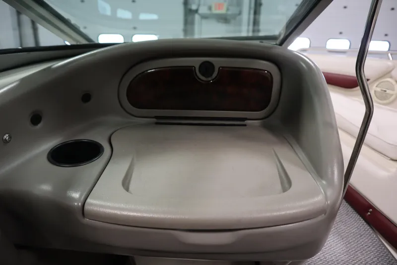 Slide: The Image of 2003 Crownline 202 BR boat interior with storage compartment and cup holder. - 36