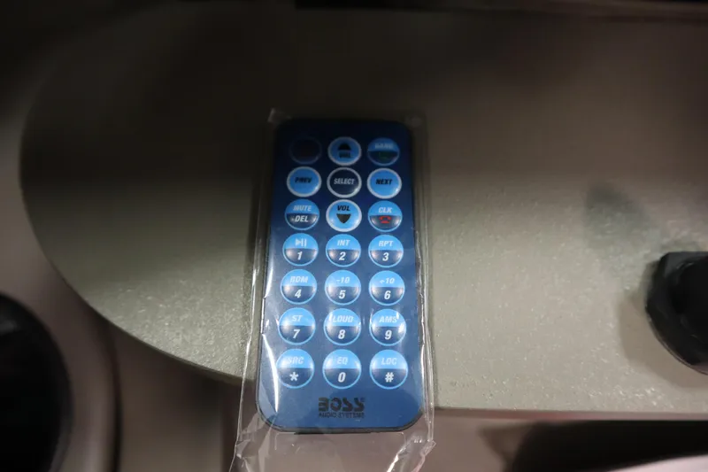 Slide: The Image of Remote control on a 2003 Crownline 202 BR boat dashboard. - 38