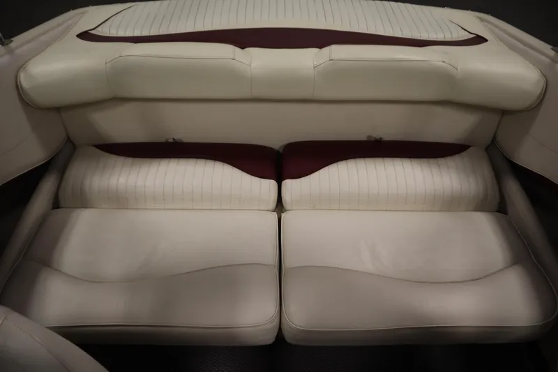 Slide: The Image of 2003 Crownline 202 BR boat interior with cream and maroon seating. - 46