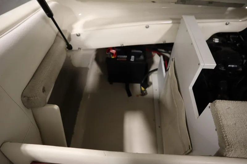 Slide: The Image of 2003 Crownline 202 BR boat interior showing battery compartment and seating area. - 49