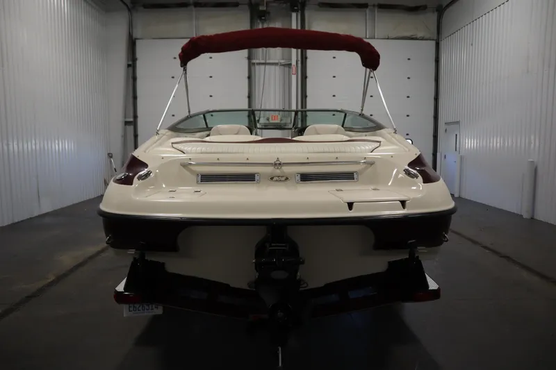 Slide: The Image of 2003 Crownline 202 BR boat in indoor storage, rear view with red canopy. - 6