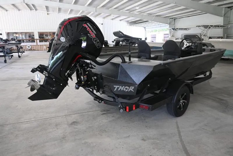 Slide: The Image of 2026 Thor Lake Hammer 1900SC boat with powerful outboard motor in a spacious indoor setting. - 4