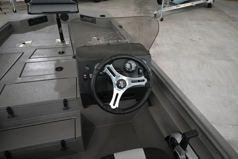 Slide: The Image of 2026 Thor Lake Hammer 1900SC boat cockpit with steering wheel and control panel. - 6