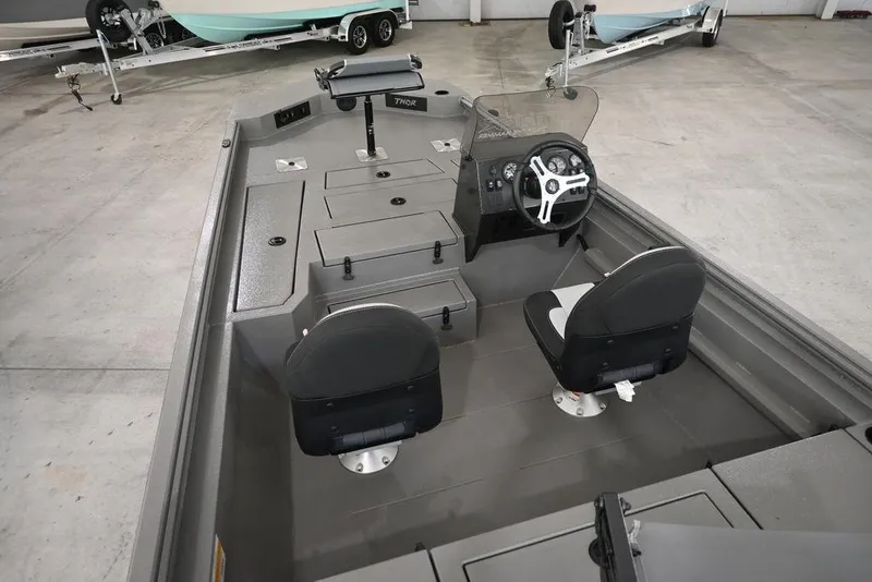 Slide: The Image of 2026 Thor Lake Hammer 1900SC boat interior with dual seats and steering console. - 9