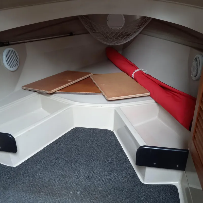 Slide: The Image of 2005 Ranger Tugs R-21 cabin interior with storage and seating area. - 10