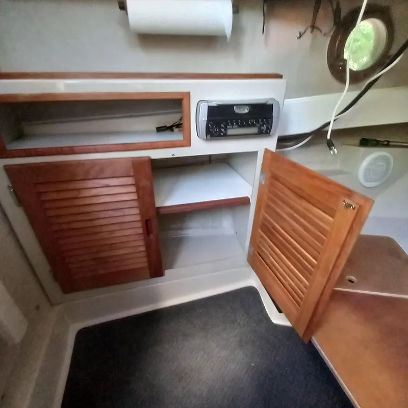 Slide: The Image of Interior of a 2005 Ranger Tugs R-21 boat with wooden cabinets and stereo system. - 16