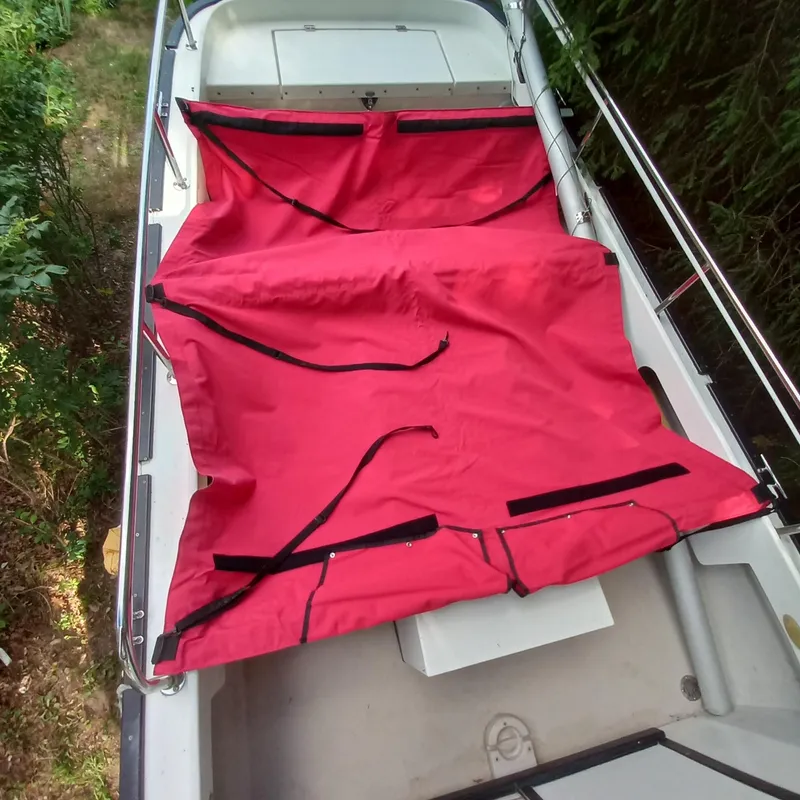 Slide: The Image of 2005 Ranger Tugs R-21 boat with red cover, viewed from above. - 22
