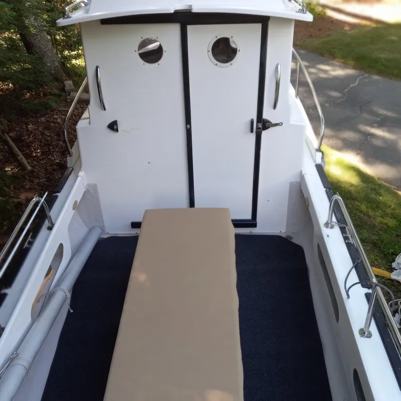 Slide: The Image of 2005 Ranger Tugs R-21 boat deck with cabin doors and portholes. - 23