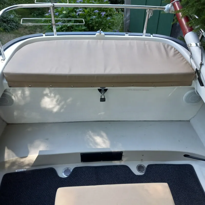 Slide: The Image of 2005 Ranger Tugs R-21 boat interior with cushioned seating and railing. - 25
