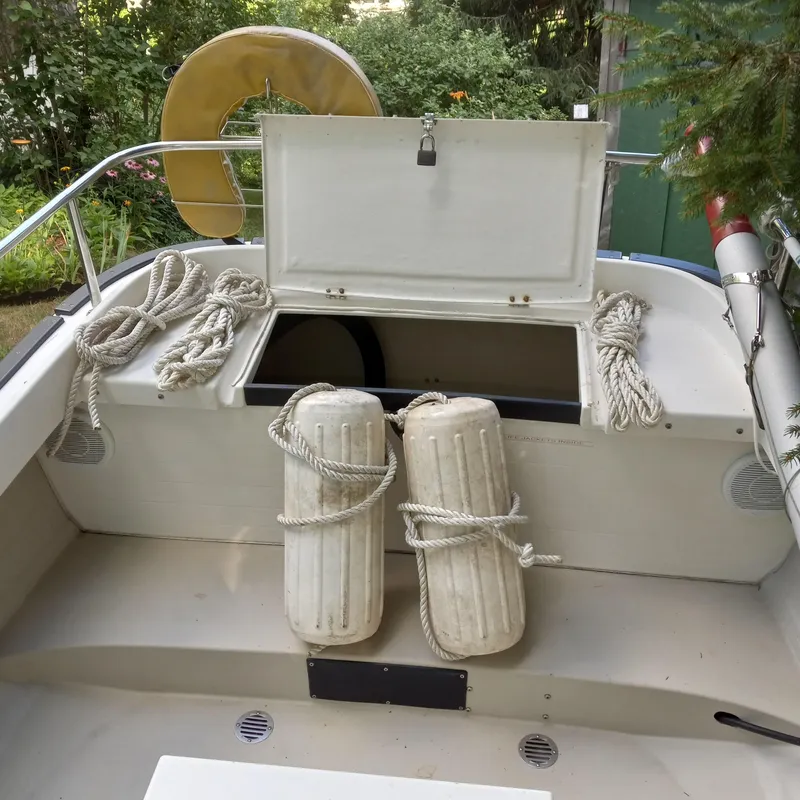 Slide: The Image of 2005 Ranger Tugs R-21 boat deck with ropes, fenders, and storage compartment. - 26