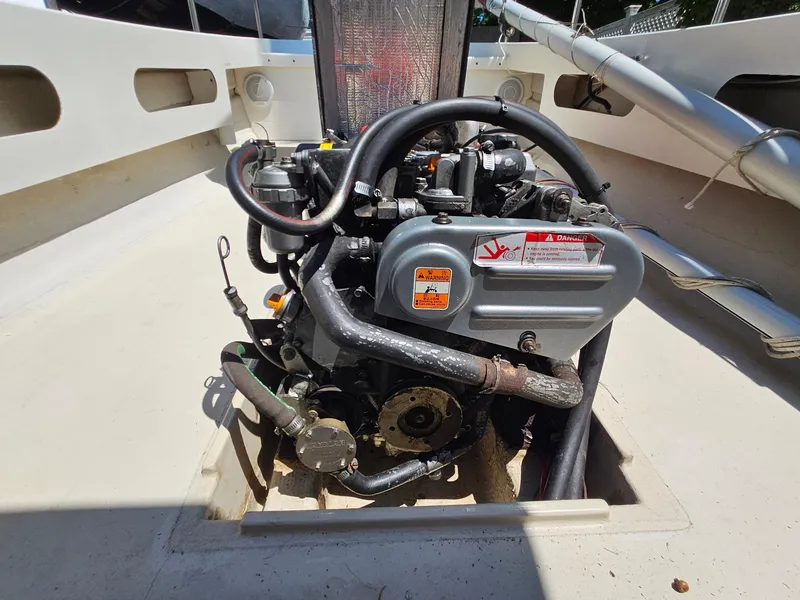 Slide: The Image of Engine of a 2005 Ranger Tugs R-21 boat, exposed in the deck area. - 28