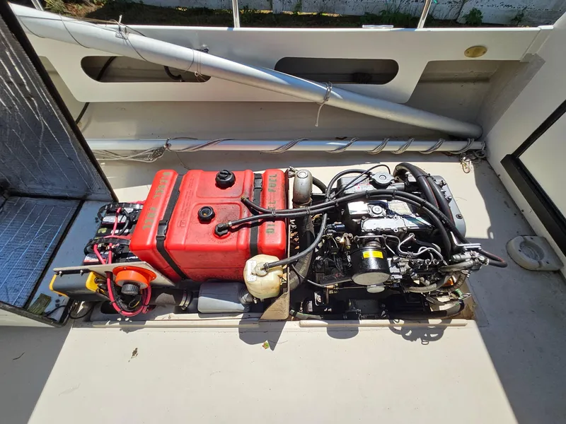 Slide: The Image of Engine compartment of a 2005 Ranger Tugs R-21, featuring a red fuel tank and mechanical components. - 30