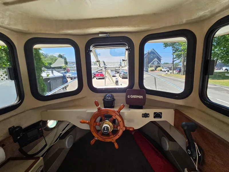 Slide: The Image of Interior view of 2005 Ranger Tugs R-21 boat with steering wheel and Garmin navigation system. - 6