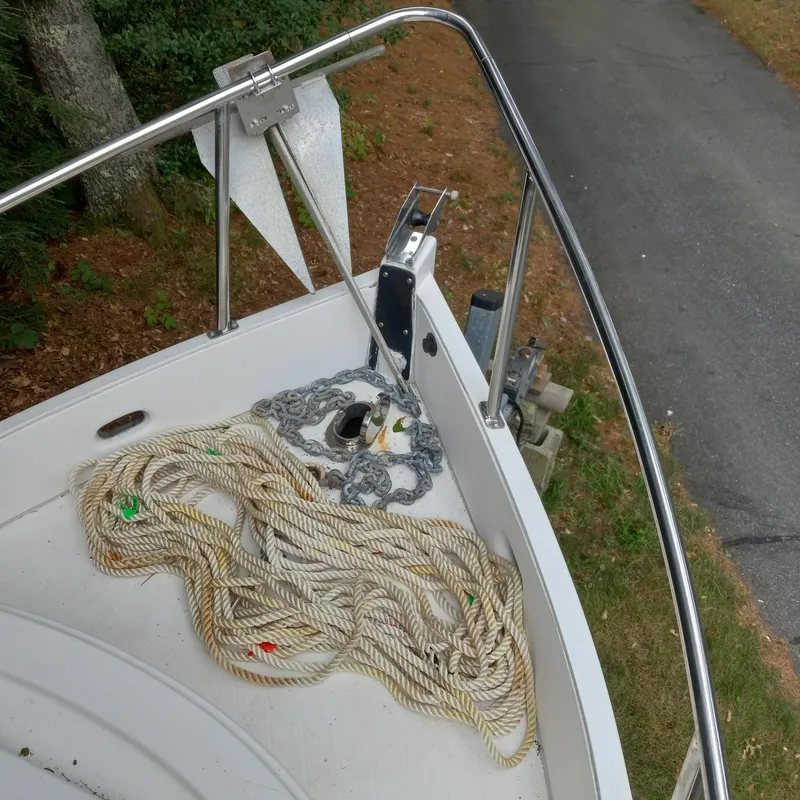 Slide: The Image of 2005 Ranger Tugs R-21 boat deck with ropes and anchor, docked on a grassy area. - 8