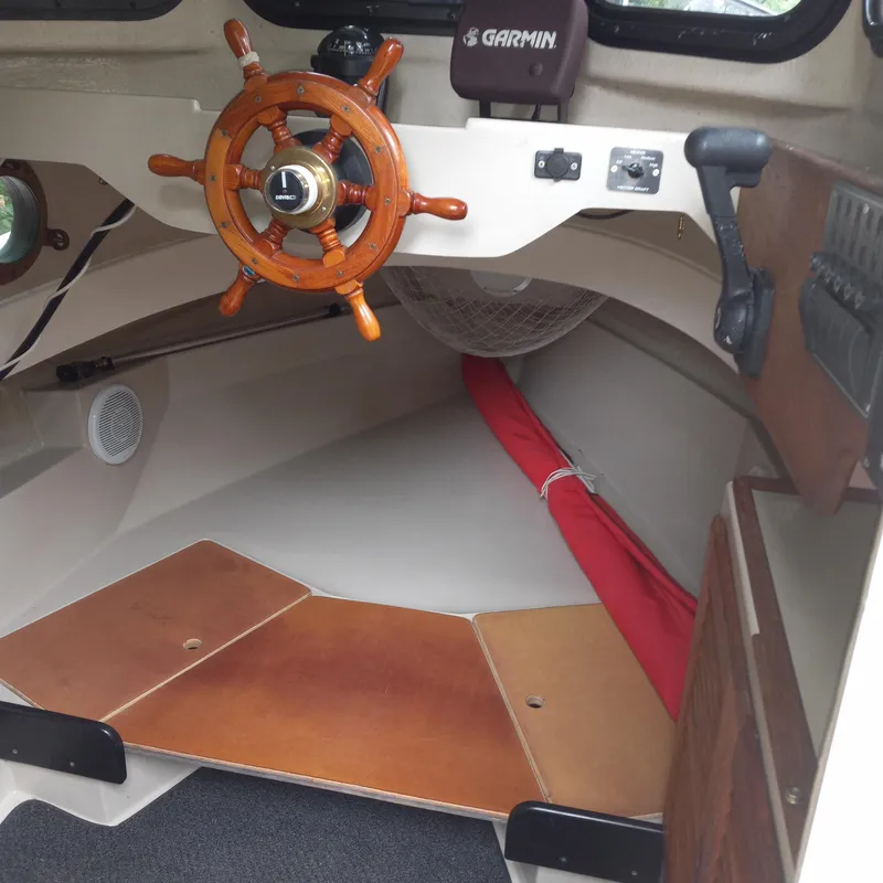 Slide: The Image of Interior of 2005 Ranger Tugs R-21 boat with wooden steering wheel and Garmin device. - 9