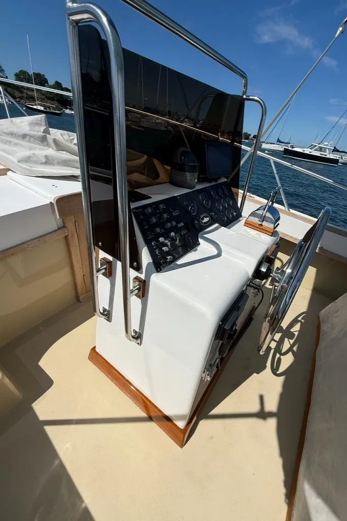 Slide: The Image of Control panel of a 1986 Dusky 26 Custom boat with steering wheel and gauges. - 14