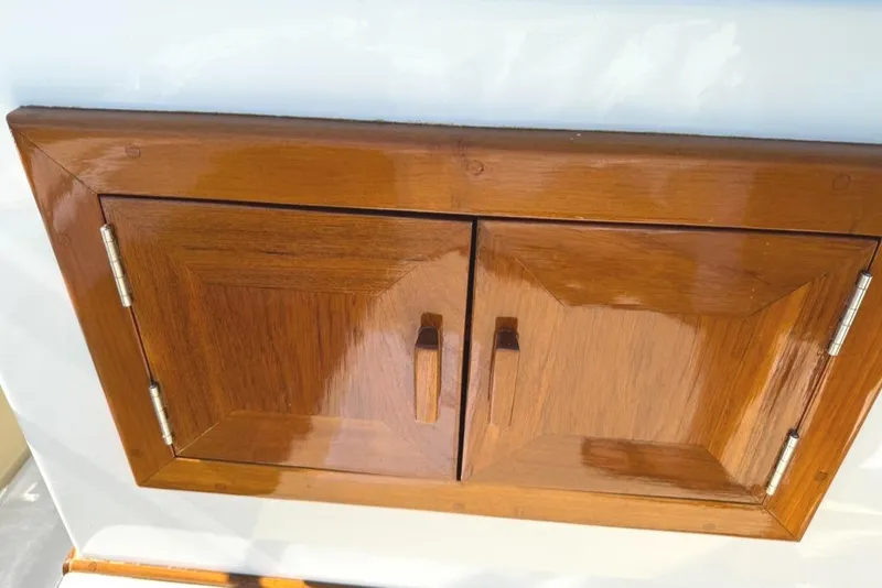 Slide: The Image of Wooden cabinet doors on a 1986 Dusky 26 Custom boat. - 16