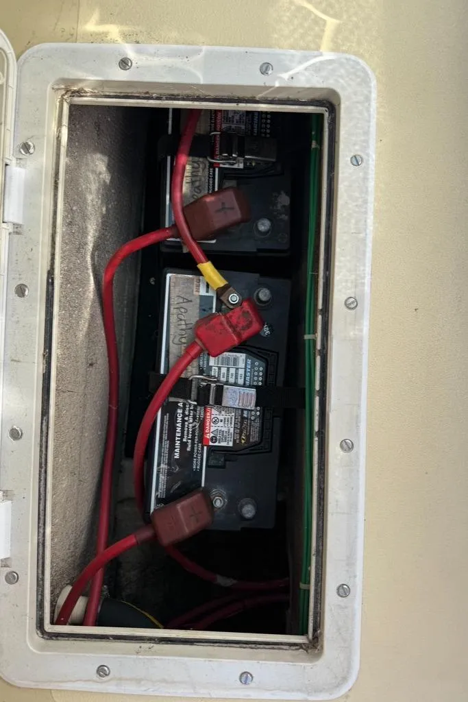 Slide: The Image of Battery compartment of a 1986 Dusky 26 Custom boat with red cables. - 18