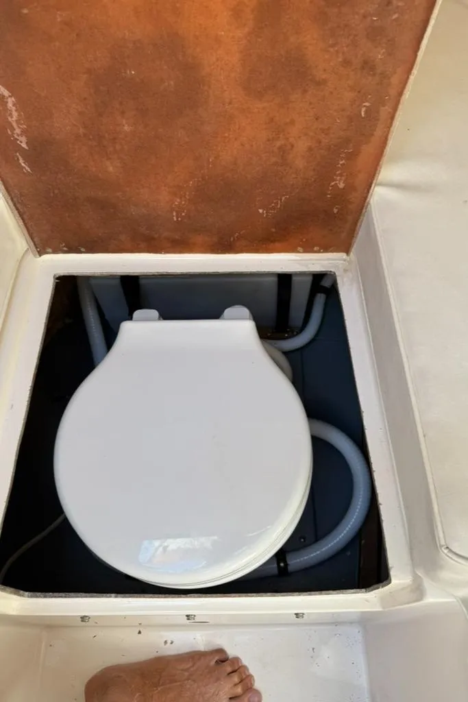 Slide: The Image of Boat toilet in 1986 Dusky 26 Custom, open compartment view. - 22