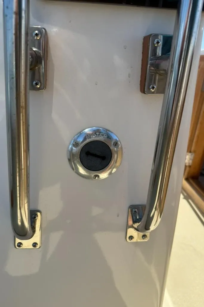 Slide: The Image of 1986 Dusky 26 Custom boat detail with stainless steel handles and water inlet. - 24