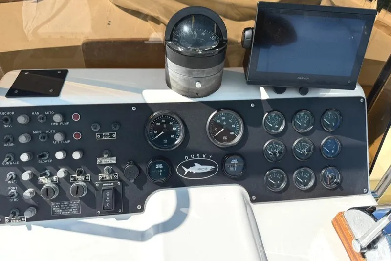Slide: The Image of Control panel of a 1986 Dusky 26 Custom boat with gauges and navigation equipment. - 3