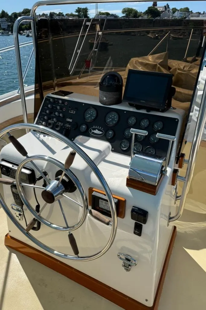 Slide: The Image of 1986 Dusky 26 Custom boat dashboard with steering wheel and navigation instruments. - 4