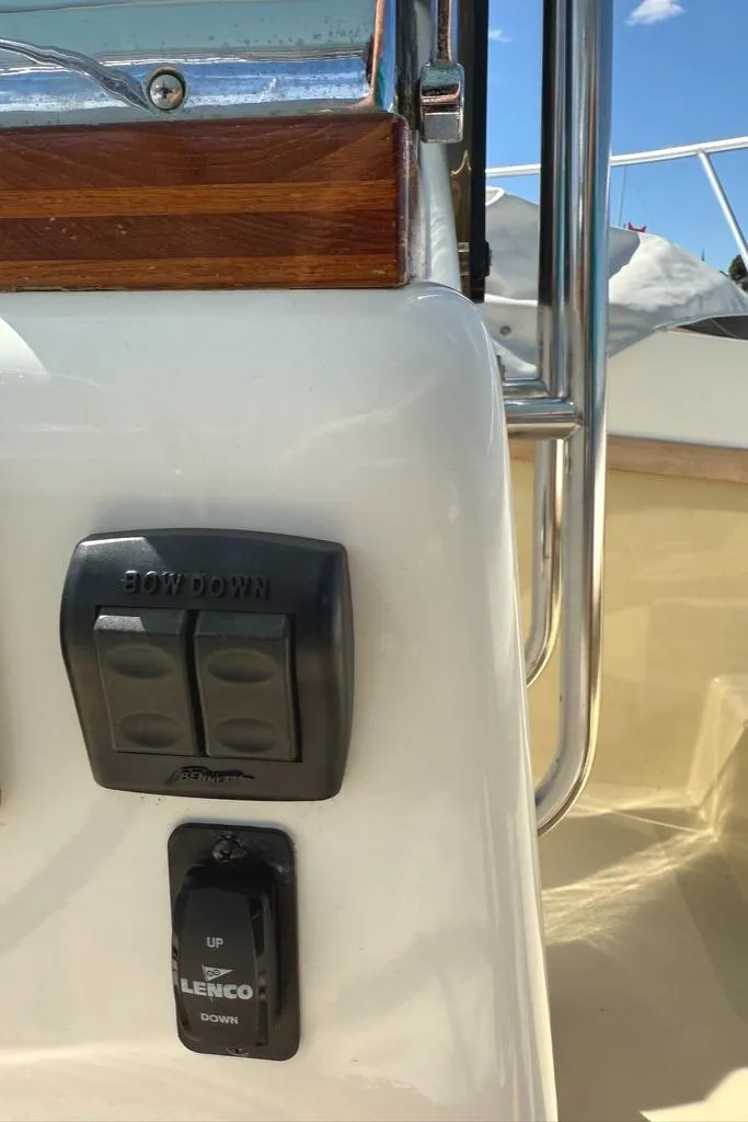 Slide: The Image of Control panel on a 1986 Dusky 26 Custom boat with Lenco trim tab switches. - 5