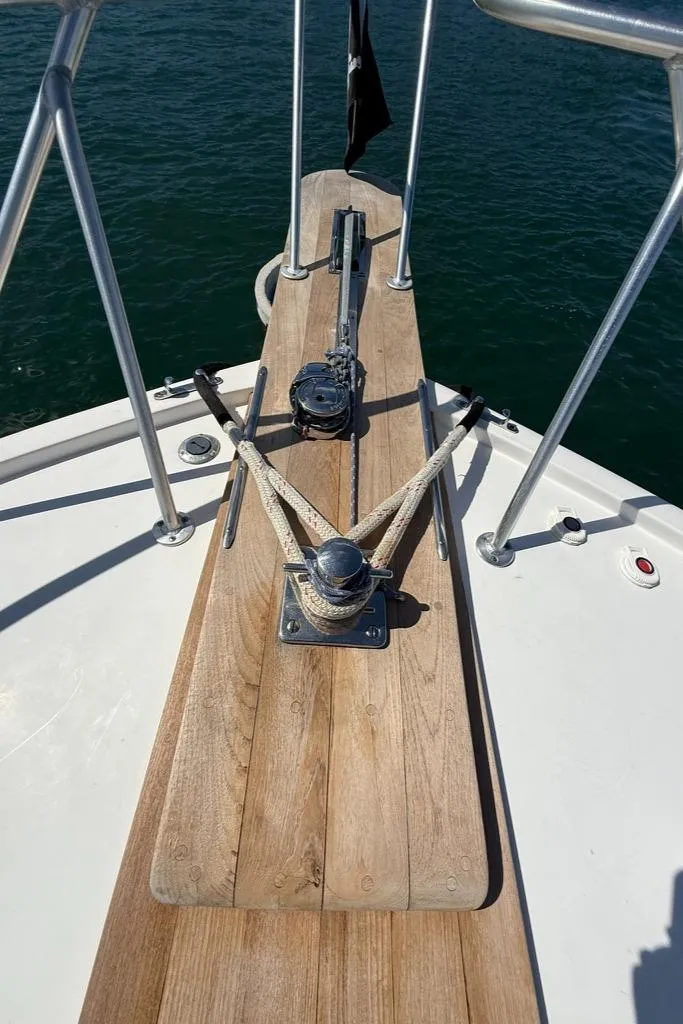 Slide: The Image of Bow of 1986 Dusky 26 Custom boat with anchor and wooden deck. - 7