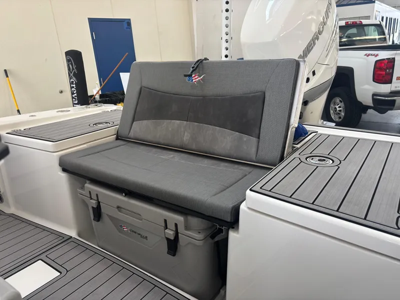Slide: The Image of 2022 Crevalle 26 HCO boat interior with cushioned seating and sleek design. - 11