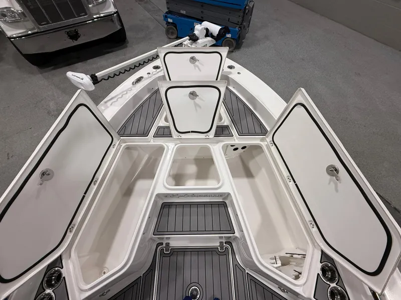 Slide: The Image of 2022 Crevalle 26 HCO boat interior with cushioned seating and storage compartment. - 13