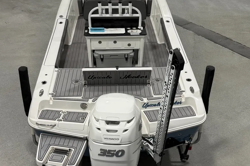 Slide: The Image of 2022 Crevalle 26 HCO boat with open storage compartments and sleek design. - 15