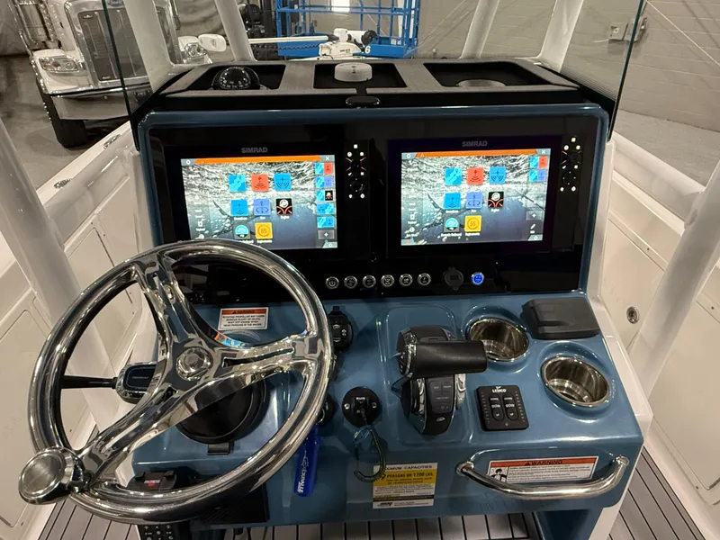 Slide: The Image of 2022 Crevalle 26 HCO boat interior with seating and trolling motor. - 16