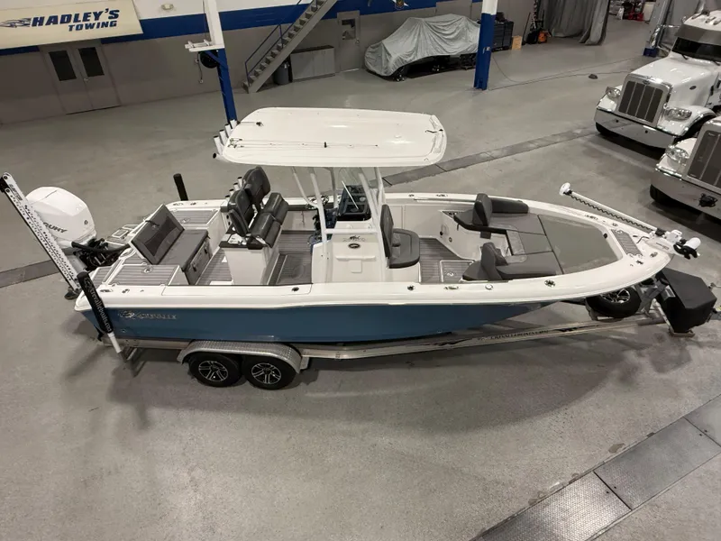 Slide: The Image of 2022 Crevalle 26 HCO boat in a spacious indoor facility. - 2