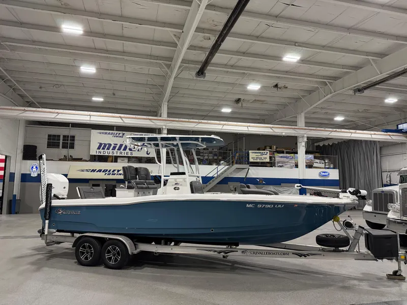 Slide: The Image of 2022 Crevalle 26 HCO boat with Mercury engine in a garage setting. - 3