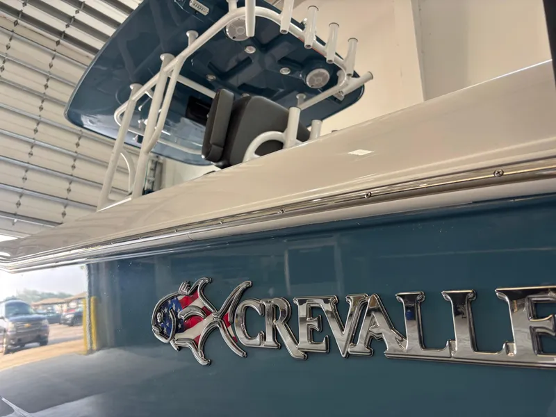 Slide: The Image of 2022 Crevalle 26 HCO boat on trailer in indoor showroom setting. - 5
