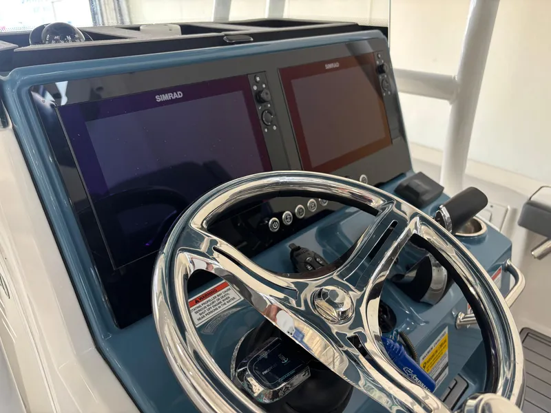 Slide: The Image of 2022 Crevalle 26 HCO boat covered on a trailer in a driveway. - 6