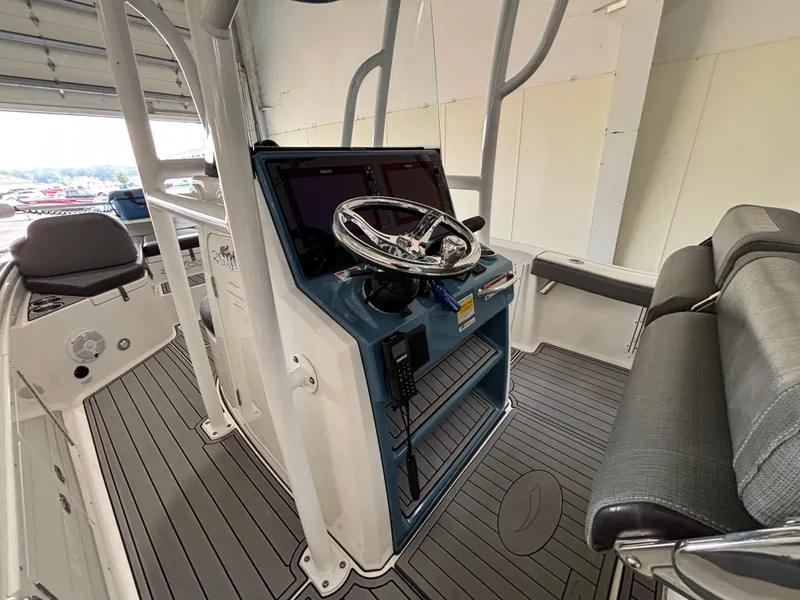 Slide: The Image of 2022 Crevalle 26 HCO boat in a garage, showcasing logo and sleek design. - 7